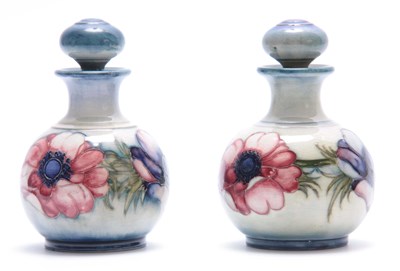 Lot 43 - A NEAR PAIR OF MOORCROFT BULBOUS TOILET WATER...