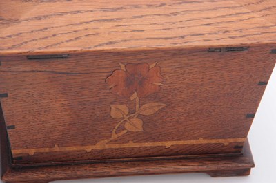 Lot 953 - AN ARTS AND CRAFT INLAID OAK TEA CADDY of...