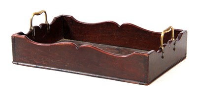 Lot 1121 - A GEORGE III MAHOGANY LIBRARY TRAY with shaped...