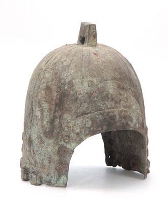 Lot 251 - A CHINESE BRONZE HELMET, PROBABLY HAN DYNASTY...