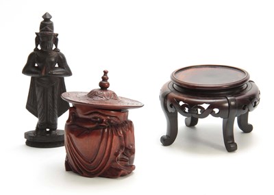 Lot 275 - AN ORIENTAL CARVED HARDWOOD CONTAINER modelled...