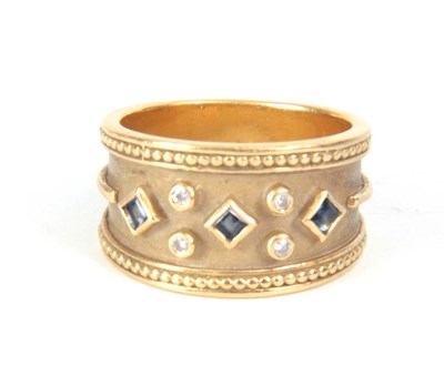 Lot 303 - AN 18CT GOLD DIAMOND AND SAPPHIRE RING with a...