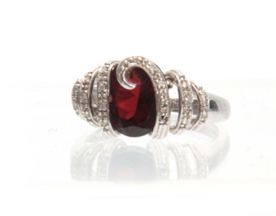 Lot 304 - A 14ct WHITE GOLD RUBY AND DIAMOND RING having...