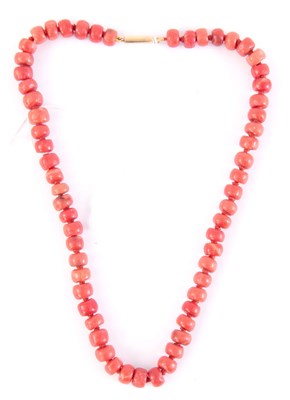 Lot 309 - A CORAL BEAD NECKLACE with yellow metal mounts...