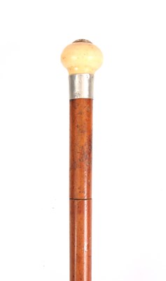 Lot 434 - A 19TH CENTURY MALACA AND IVORY SWORD STICK...
