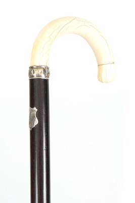 Lot 435 - A 19TH CENTURY IVORY AND ROSEWOOD WALKING CANE...