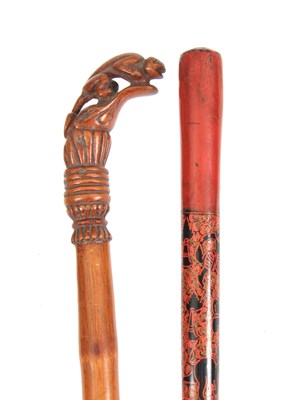 Lot 462 - TWO EASTERN WALKING CANES one handle carved...