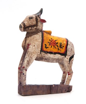 Lot 502 - A CARVED AND PAINTED HINDU NANDI COW 31cm high...