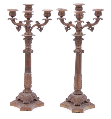 Lot 713 - A PAIR OF REGENCY STYLE FOUR BRANCH BRASS...