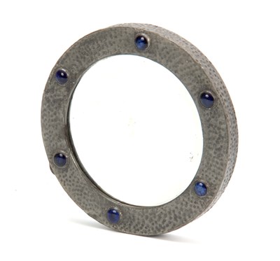 Lot 950 - AN ARTS AND CRAFTS HAMMERED PEWTER CIRCULAR...
