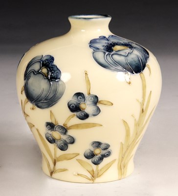 Lot 56 - A Moorcroft Style cream glazed squat bulbous...