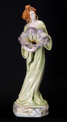 Lot 40 - AN ART NOUVEAU GLAZED POTTERY FIGURE modelled...