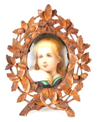 Lot 92 - A LATE 19TH CENTURY GERMAN PORCELAIN PLAQUE IN CARVED BLACK FOREST FRAME