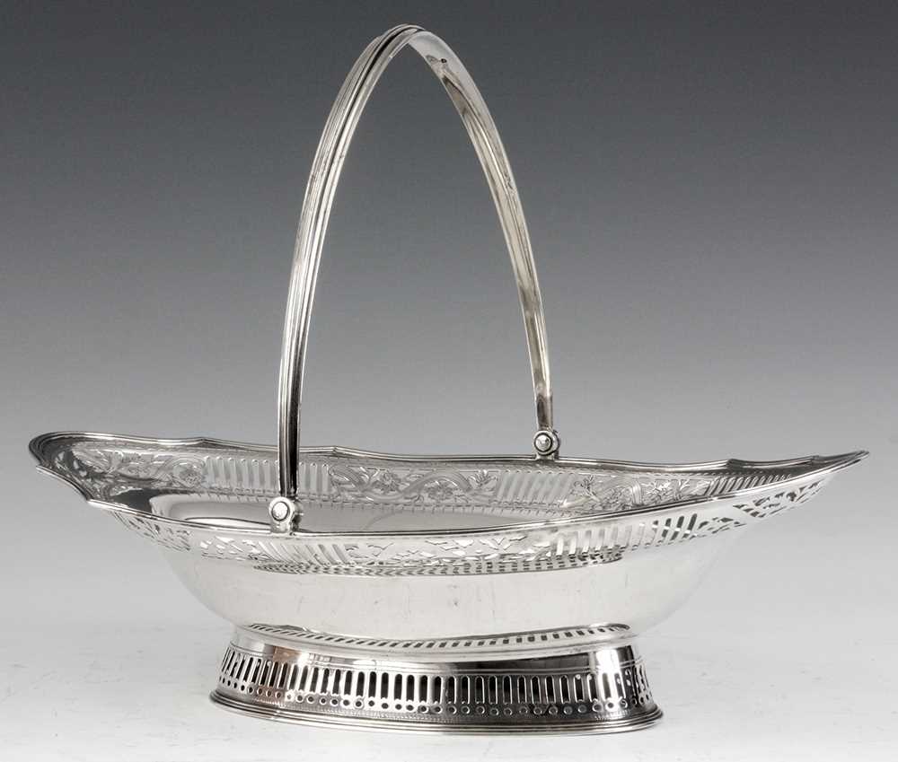 Lot 297 - A GEORGE III LARGE SILVER FRUIT BASKET of oval...