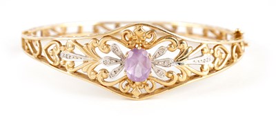 Lot 347 - A LADIES 9CT GOLD DIAMOND AND AMETHYST BANGLE...