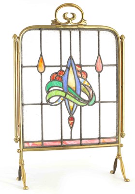 Lot 590 - AN ART NOUVEAU BRASS AND STAINED GLASS FIRE...
