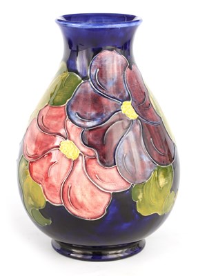 Lot 71 - A WALTER MOORCROFT FOOTED OVOID VASE decorated...