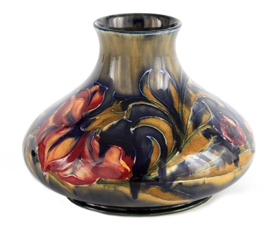 Lot 91 - A WILLIAM MOORCROFT BURSLEM SQUAT BULBOUS VASE...