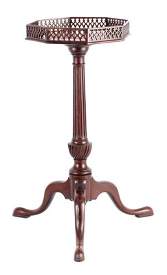 Lot 1012 - A GEORGE III FIGURED MAHOGANY KETTLE STAND