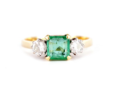 Lot 238 - A LADIES 18CT GOLD THREE STONE EMERALD AND DIAMOND RING