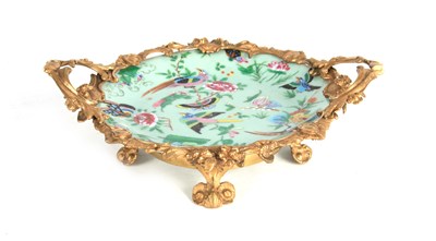 Lot 180 - A LATE 19TH CENTURY ORMOLU MOUNTED FAMILLE ROSE CELADON DISH