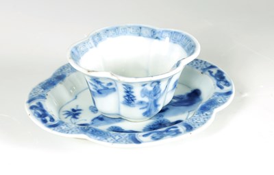 Lot 215 - AN 18TH CENTURY CHINESE KANGXI BLUE AND WHITE SHAPED CUP AND SAUCER