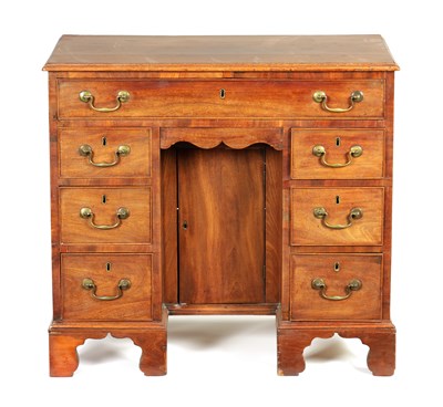 Lot 714 - A GEORGE III MAHOGANY KNEEHOLE DESK