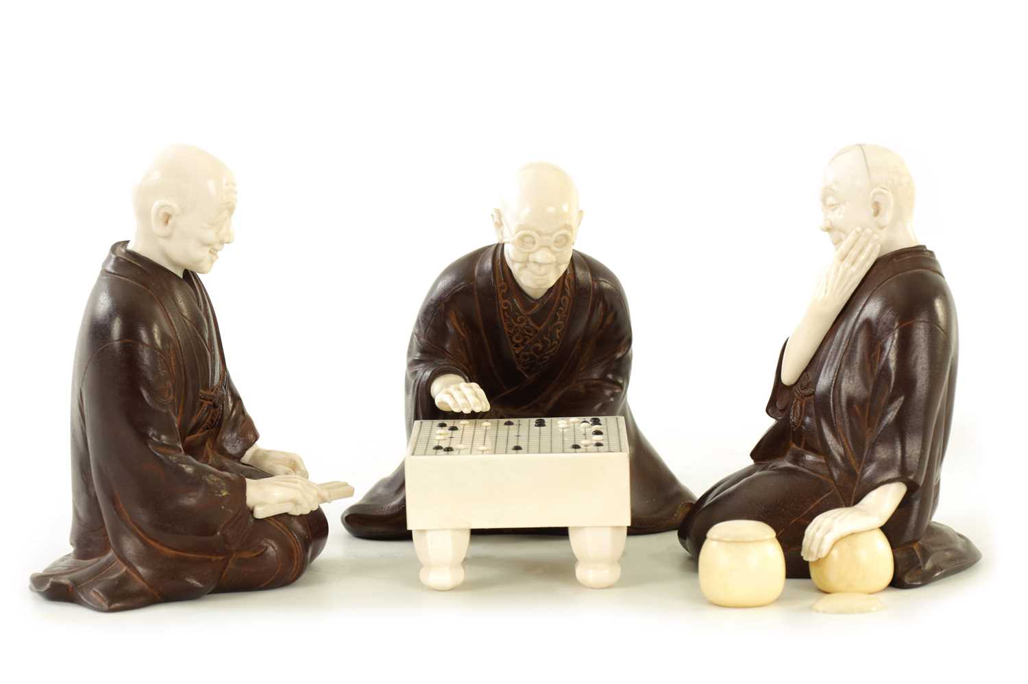 Lot 152 - A JAPANESE MEIJI PERIOD BRONZE AND IVORY FIGURAL GROUP OF THREE ELDERS PLAYING GO & GO BANG GAME
