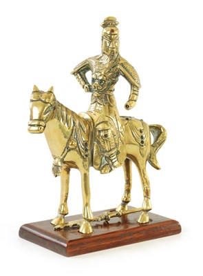 Lot 81 - AN EARLY PERIOD CHINESE CAST BRASS MODEL OF A KNIGHT ON HORSEBACK