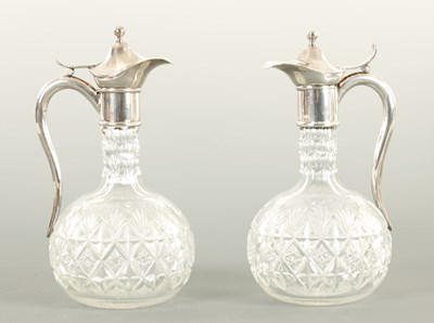 Lot 29 - AN UNUSUAL PAIR OF HALF SIZE SILVER METAL MOUNTED CUT GLASS CLARET  JUGS CIRCA 1900