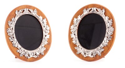 Lot 413 - A PAIR OF GEORGE V OVAL OAK FRAMED AND SILVER MOUNTED PHOTO FRAMES