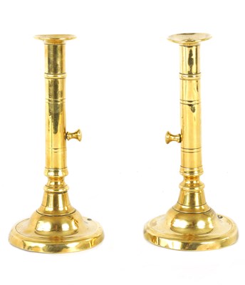 Lot 86 - A PAIR OF GEORGIAN BRASS EJECTOR CANDLESTICKS