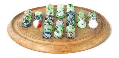 Lot 95 - A VICTORIAN ELM SOLITAIRE BOARD AND MARBLES