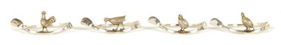Lot 318 - OF COUNTRY SPORTS INTEREST - A SET OF FOUR EARLY 20TH CENTURY SILVER NAPKIN HOLDERS