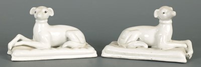Lot 111 - A PAIR OF WHITE PORCELAIN FIGURES OF RECUMBENT HOUNDS