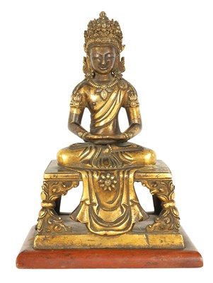 Lot 203 - AN EARLY GILT BRONZE TIBETAN BUDDHA DEPICTING AKSHOBHYA
