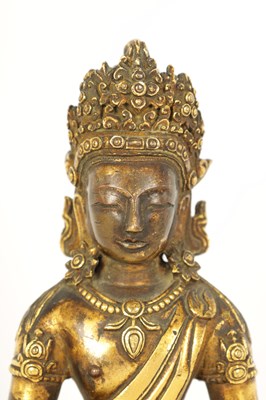 Lot 203 - AN EARLY GILT BRONZE TIBETAN BUDDHA DEPICTING AKSHOBHYA