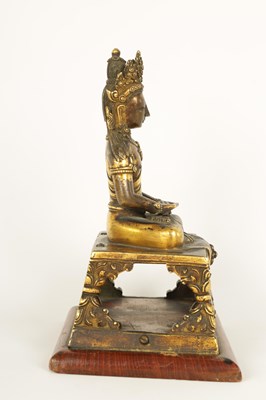 Lot 203 - AN EARLY GILT BRONZE TIBETAN BUDDHA DEPICTING AKSHOBHYA