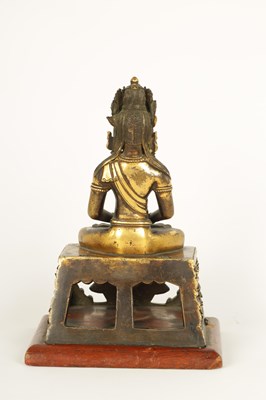 Lot 203 - AN EARLY GILT BRONZE TIBETAN BUDDHA DEPICTING AKSHOBHYA
