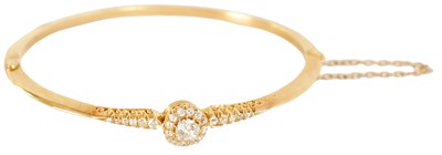 Lot 240 - A LADIES 18CT GOLD AND DIAMOND BANGLE