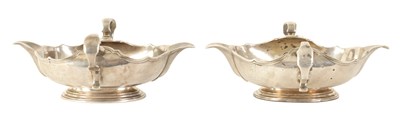 Lot 329 - AN IMPORTANT AND RARE PAIR OF GEORGE I CAST SILVER DOUBLE LIPPED SAUCE BOATS BY PIERRE PLATEL DATED 1717