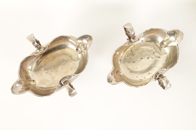 Lot 329 - AN IMPORTANT AND RARE PAIR OF GEORGE I CAST SILVER DOUBLE LIPPED SAUCE BOATS BY PIERRE PLATEL DATED 1717