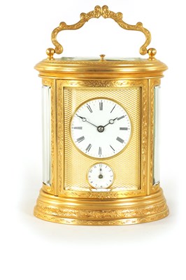 Lot 696 - A LATE 19TH CENTURY OVAL ENGRAVED GILT BRASS REPEATING CARRIAGE CLOCK