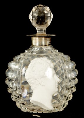 Lot 7 - AN UNUSUAL 19TH CENTURY SULPHIDE MASK HEAD AND CUT GLASS  TOILET WATER BOTTLE AND STOPPER