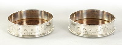 Lot 304 - A PAIR OF ELIZABETH II SILVER WINE BOTTLE COASTERS