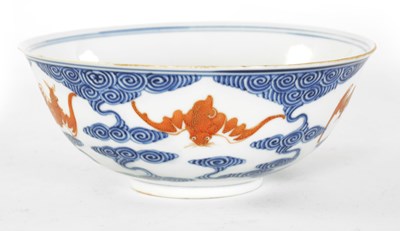 Lot 141 - A CHINESE GUANGXI PERIOD IRON-RED-DECORATED BLUE AND WHITE BAT BOWL
