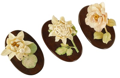 Lot 110 - A GARNITURE OF THREE LATE 19TH CENTURY COLOURED STAINED IVORY FLOWER SPRAY SCULPTURES