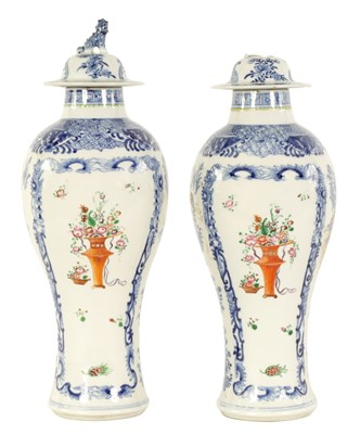 Lot 184 - A PAIR OF 19TH CENTURY CHINESE FAMILLE ROSE BLUE AND WHITE SLENDER INVERTED BALUSTER VASES AND COVERS