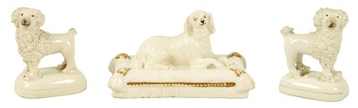 Lot 1248 - AN EARLY 19TH CENTURY BLANC DE CHINE PORCELANEOUS RECUMBENT DOG AND A PAIR OF MINIATURE POODLES