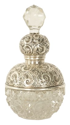 Lot 1375 - A GEORGE V SILVER TOPPED CUT GLASS PERFUME BOTTLE